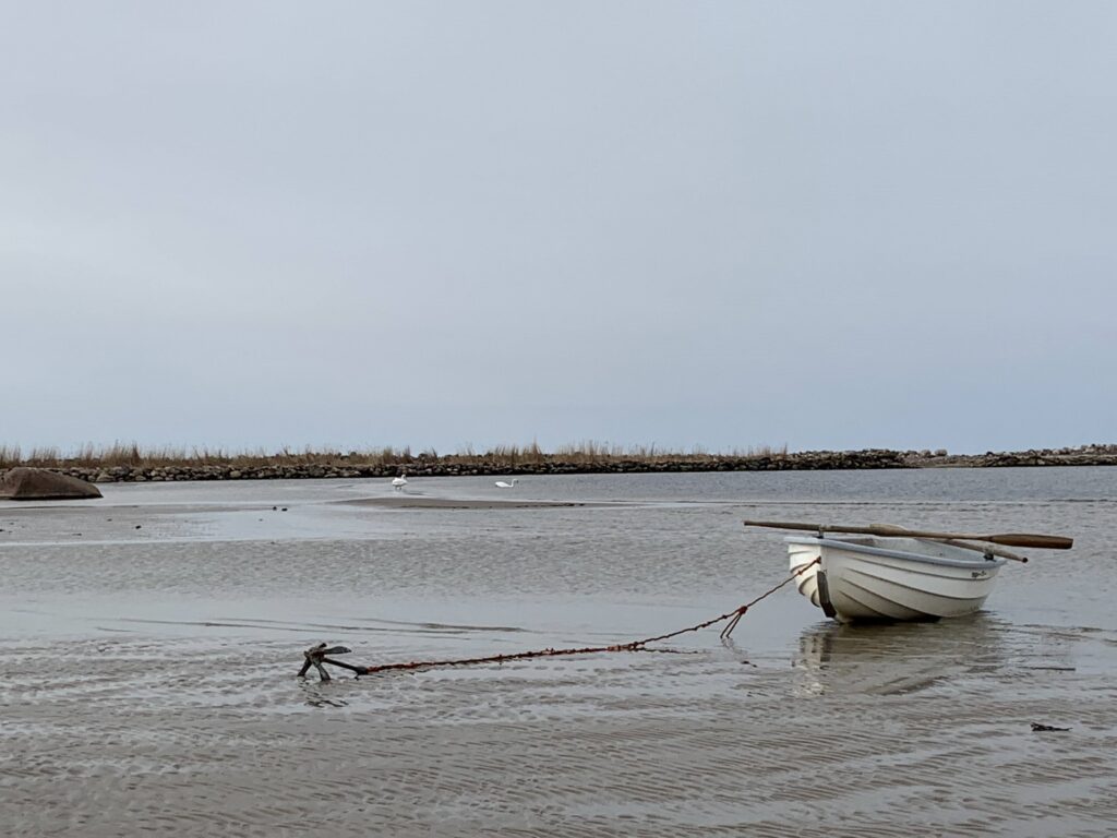 White rowboat on calm Baltic Sea shore in Treimani near the Latvian border